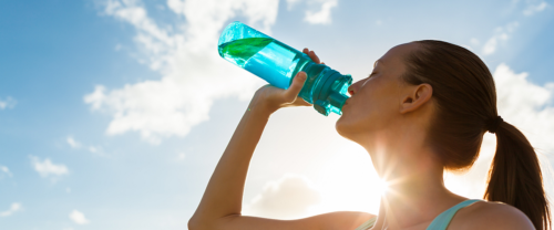 Woman drink bottle water sun sky