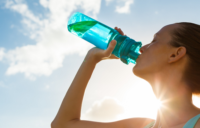 Woman drink bottle water sun sky