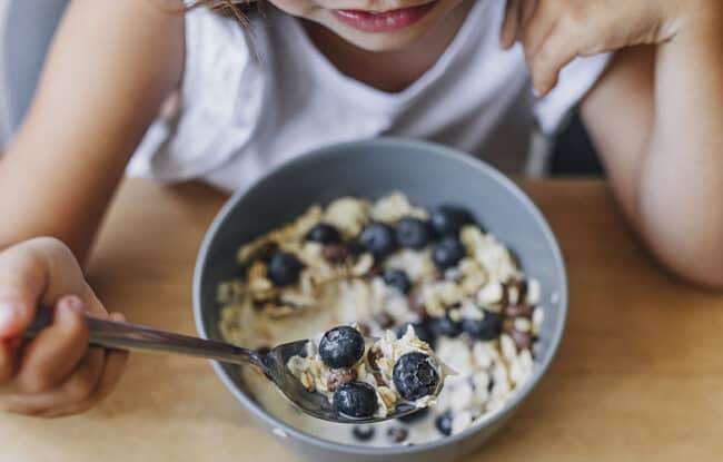child eating breakfast