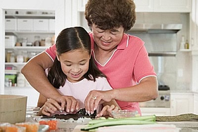 girl and grandmother making sushi