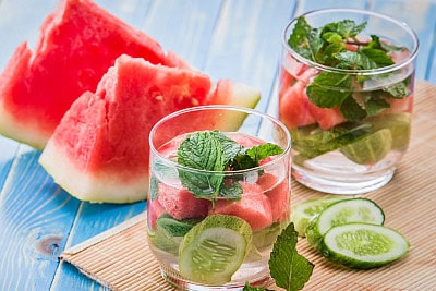 water with watermelon, cucumbers, and mint