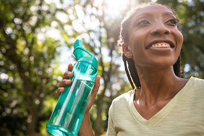 woman outside drinking water