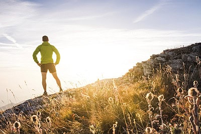 man hiking up a mountain