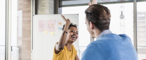 co-workers high-fiving each other