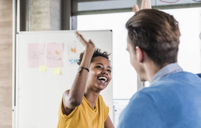 co-workers high-fiving each other