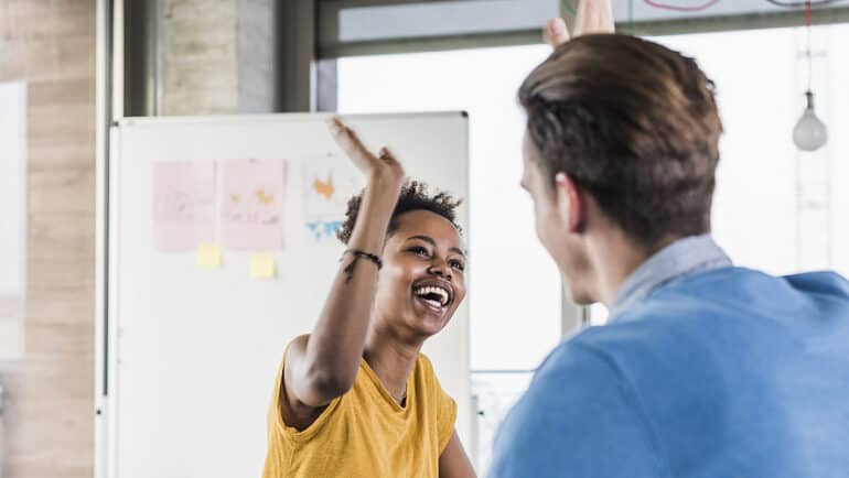 co-workers high-fiving each other