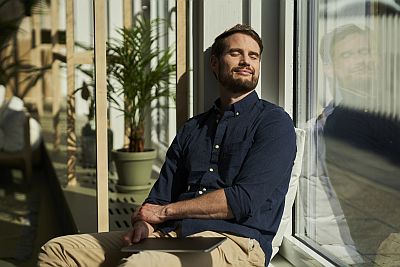 man sitting in the sun relaxing and meditating