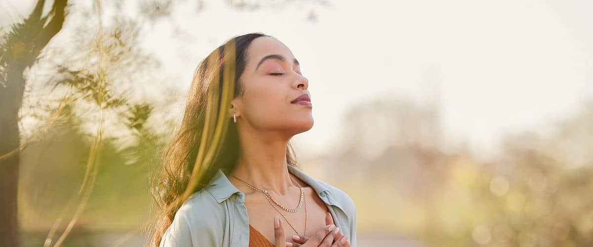 woman meditating and breathing outside