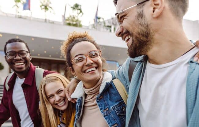 4 college friends smiling