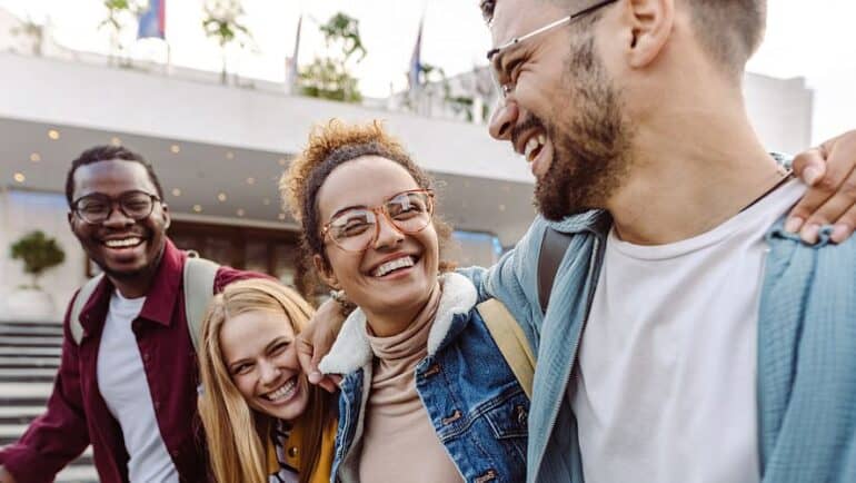 4 college friends smiling